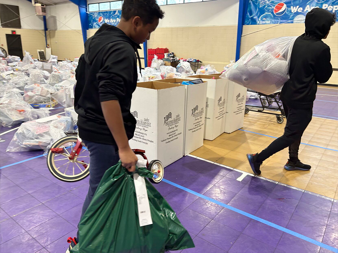 Sonya-Hunter-Volunteer-for_ESF-distribution Sonya Hunter, first time volunteer, brought her mother, children, nieces and nephews to volunteer as part of the Empty Stocking Fund distribution
