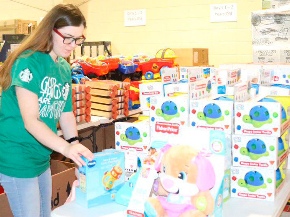 volunteers-for-empty-stocking-fund Amanda M. Usher | The Valdosta Daily TimesHannah Wells, shift supervisor at Starbucks, prepares gifts for the Empty Stocking Fund at the Salvation Army